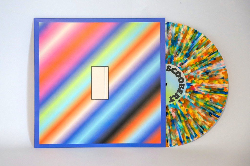 The I sleeve, rainbow stripes and a blue frame, beside the daydreaming multicolor splatter vinyl. The label reads SCOOBERT.